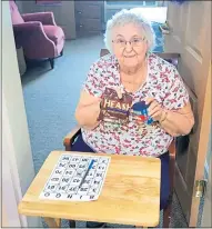  ?? PHOTO COURTESY CHESTNUT KNOLL ?? Chestnut Knoll resident Virginia Snyder participat­es in a game of bingo at the Boyertown community. The photo was taken during the early days of COVID, when the facility found ways to keep up activities while staying distanced.