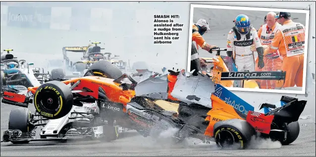  ?? Main picture: FRANCOIS LENOIR ?? SMASH HIT: Alonso is assisted after a nudge from Hulkenberg sent his car airborne