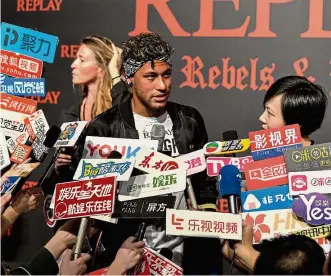  ?? — AFP ?? In the spotlight: Neymar speaks to the media at a fashion event in Shanghai on Monday.