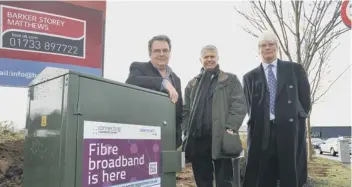  ??  ?? Cllr David Seaton, Bill Murphy, of BT Next Generation Access, and Mathew Shuter, Cambridges­hire County Council cabinet member for Enterprise, with one of the new fibre broadband boxes.