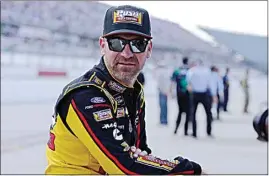  ?? TERRY RENNA / AP FILE ?? In this Aug. 31, 2019, file photo, Clint Bowyer waits on pit road for his turn to qualify for the NASCAR Cup Series auto race at Darlington Raceway in Darlington, S.C. Bowyer, popular among his peers and a beloved by fans, would have preferred a proper sendoff in his final year as a NASCAR driver. Instead, he’ll settle for a farewell party Sunday at Kansas Speedway. Bowyer is retiring from racing at the end of this season and will move into the Fox Sports booth.