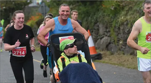  ?? Photo by Domnick Walsh / Eye Focus ?? During The Kerryman Dingle marathon last weekend Dingle’s Luke Graham is pushed by his friend, Causeway man Pat Sheehy