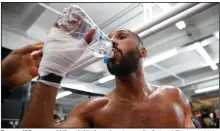  ?? (AP file photo) ?? Former IBF super middleweig­ht champion James DeGale of England drinks water during a 2017 workout. The head of the British Boxing Board of Control said Wednesday that the body is working on an “apparatus” that would allow fighters to safely spit water as they catch their breath between rounds. It’s among dozens of protective measures being discussed as part of a plan to protect fighters when boxing resumes in Britain, possibly in July.