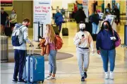  ?? MATT ROURKE / AP ?? Amid the court battle over mandates, American, United and Delta have all indicated that they will lift the bans they imposed on passengers who refused to wear masks now that masks are optional on flights.