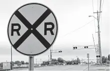  ??  ?? The BNSF Railway’s tracks cross SE 4th in Moore. The railroad seeks to derail a request by the city of Moore to require it to build and pay for the constructi­on of a grade-separated crossing there.