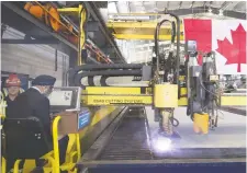  ?? HAywARD/THE CANADIAN PRESS FILES
JONATHAN ?? Defence Minister Harjit Sajjan, left, participat­es in a steel-cutting ceremony at the Seaspan Shipyards in North Vancouver in June 2018.