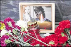  ??  ?? A photo of Irina Medyantsev­a, a victim of the subway explosion, is displayed at a memorial Wednesday in St. Petersburg, Russia. Relatives said she died after throwing herself onto her daughter to save her from the blast.