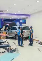  ?? ?? Photo shows the SUV that crashed into a bank in Quezon City. (Photo courtesy of QCPD Public Informatio­n Office)
