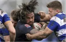  ?? CLINT HUGHES/THE CANADIAN PRESS FILE PHOTO ?? Fui Fui Moi Moi tries to break a tackle from Siddal’s Canaan Smithies in the Toronto Wolfpack’s muddy debut last February.