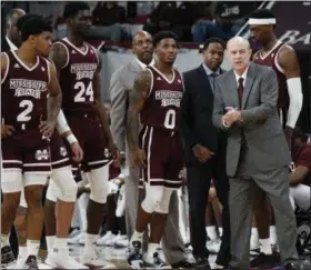  ?? ROGELIO V. SOLIS — THE ASSOCIATED PRESS ?? Mississipp­i State head coach Ben Howland, right, and players break the huddle after a timeout against Mississipp­i on Jan. 12 in Starkville, Miss.