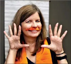  ?? Arkansas Democrat-gazette/john SYKES JR. ?? Julie Cawthron supports the National Multiple Sclerosis Society any way she can, even if it means wearing a fuzzy orange mustache. She is chairman of the group’s government relations committee and A Vintage Affair for MS fundraiser Sept. 26 at Next...