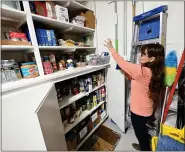  ?? JENNY SPARKS — LOVELAND REPORTER-HERALD ?? Wendy Yates, Little Free Pantry mission leader at Trinity United Methodist Church, shows the food storage area they use to help people with food from the Little Free Pantry at the church.