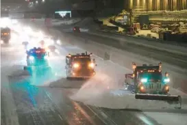  ?? DAVID JOLES/STAR TRIBUNE ?? Snowplows work to clear a stretch of Interstate 35 Wednesday in Minneapoli­s. Harsh weather in Minnesota forced closure of schools and the state Legislatur­e.