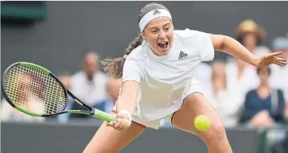  ?? GLYN KIRK/AFP/GETTY IMAGES ?? Jelena Ostapenko returns against Dominika Cibulkova in their Wimbledon quarterfin­al match on Tuesday. Ostapenko won 7-5, 6-4.