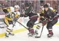  ?? CHRISTIAN PETERSEN/GETTY IMAGES ?? The Coyotes traded defenseman Shayne Gostisbehe­re (center, during a Jan. 8 game against the Pittsburgh Penguins) to the Carolina Hurricanes for a third-round pick in the 2026 draft.