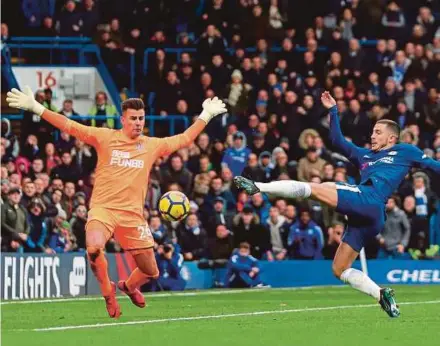  ?? AFP PIC ?? Chelsea’s Eden Hazard’s (right) shot is saved by Newcastle United goalkeeper Karl Darlow in a Premier League match at Stamford Bridge yesterday.