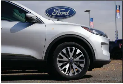  ?? (AP) ?? A 2020 Ford Escape SUV sits at a dealership in Denver in this file photo. Ford said its Louisville Assembly Plant in Kentucky, which builds the Escape along with the Lincoln Corsair, will be idled this week because of the semiconduc­tor shortage.