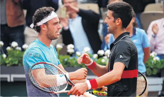  ?? PHOTO: REUTERS ?? Magnifico . . . Italian Marco Cecchinato (left) is congratula­ted by Novak Djokovic after defeating the Serb former world No 1 in Paris yesterday to reach the semifinals of the French Open. Cecchinato won 63, 76 (74), 16, 76 (1311).