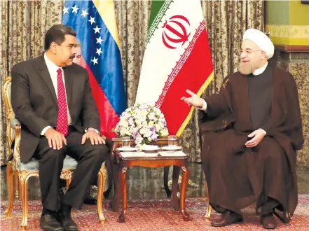  ??  ?? IRANIAN PRESIDENT Hassan Rouhani (right) meets with now-embattled Venezuelan President Nicolas Maduro, in Tehran in October 2016.