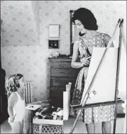  ??  ?? “Creating Camelot: The Kennedy Photograph­y of Jacques Lowe” features intimate photos of the Kennedy family, including this image of Jacqueline and daughter Caroline painting, taken by their official photograph­er Jacques Lowe.