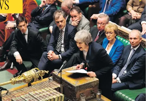  ?? MARK DUFFY / UK PARLIAMENT / AFP / GETTY IMAGES ?? British Prime Minister Theresa May addresses the House of Commons in London Tuesday, after MPs resounding­ly rejected her Brexit deal, triggering a no-confidence vote in her government and leaving the country on track to crash out of the EU.