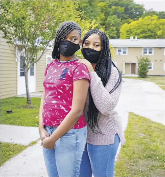  ?? Paul Buckowski / times union ?? Akira marshall, right, and her daughter, damirah Corbitt, 12, stand outside their home in Albany. Corbitt is a home school coordinato­r at the montessori magnet School for the Albany School district.