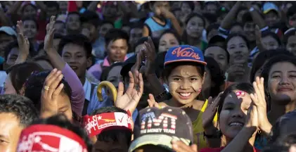  ??  ?? TAUNGOK: Supporters of Myanmar’s opposition leader Aung San Suu Kyi applaud as Suu Kyi delivers a speech during a campaign rally of National League for Democracy party in Taungok, western Rakhine state, Myanmar yesterday. — AP