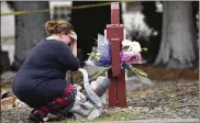  ?? JOSH EDELSON / ASSOCIATED PRESS ?? A woman who declined to give her name cries after placing flowers at a sign at the The Pathway Home’s facility in Yountville, California, on Saturday morning.