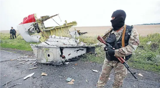  ?? Photo: Reuters ?? Wreckage: A pro-Russian separatist stands at the crash site of Malaysia Airlines flight MH17, near the settlement of Grabovo in the Donetsk region.
