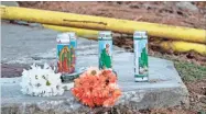  ?? AP-SCOTT ROGERS ?? Candles and flowers are left along Centennial Drive near Foundation Food Group on Jan. 29 in Gainesvill­e, Ga., in memory of the six that died from a nitrogen leak at the plant the day before.