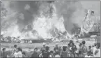  ?? Associated Press ?? Nepalese gather Friday around the wreckage of a Sita Air plane near Katmandu, Nepal.