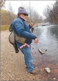  ?? (NWA Democrat-Gazette/Flip Putthoff) ?? Lawrence, of Warsaw, Mo., lands one of the dozens of rainbow trout.