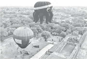  ??  ?? This aerial photograph shows hot air balloons flying over the former capital’s stone citadel during a hot air balloon festival in the central Vietnamese city of Hue. — AFP photo