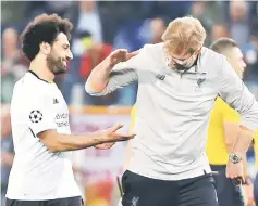  ??  ?? Liverpool manager Jurgen Klopp and Mohamed Salah celebrate after the Champions League semi-final against Roma. — Reuters photo