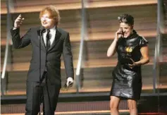  ??  ?? Ed Sheeran accepts the award for Song of theYear for“Thinking Out Loud”with songwriter Amy Wadge.