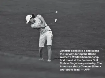  ??  ?? Jennifer Song hits a shot along the fairway during the HSBC Women’s World Championsh­ip first round at the Sentosa Golf Club in Singapore yesterday. The American shot a 7-under 65 for a two-stroke lead. — AFP