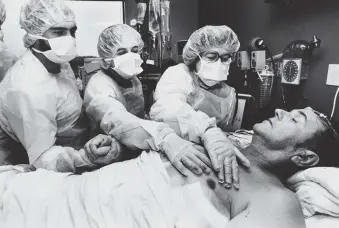  ??  ?? A patient’s family feeling the beat of an artificial heart after surgery at Humana Hospital-Audubon, Louisville, Kentucky, 1984