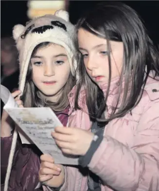  ??  ?? Lara Mcathy and Caitlin Heywood taking part in the Carols on the Green concert in Kilmacanog­ue.