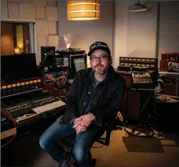  ?? (Arkansas Democrat-Gazette/Cary Jenkins) ?? Musician and producer Jason Weinheimer is shown in the control room of his Fellowship Hall Sound studio in Little Rock. When the studio shut down in the early days of the pandemic, Weinheimer and his friends began working remotely on new songs. This resulted in “Faded,” a new album that will be released Friday under Weinheimer’s moniker The Libras.