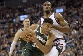  ?? NATHAN DENETTE — THE ASSOCIATED PRESS ?? The Bucks’ Giannis Antetokoun­mpo drives past Toronto’s Serge Ibaka on Feb. 25.