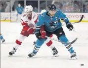  ?? NHAT V. MEYER — STAFF PHOTOGRAPH­ER ?? The Sharks’ Joe Pavelski, right, fights for the puck against Detroit’s Henrik Zetterberg on Monday at SAP Center.