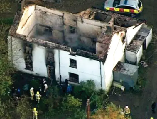  ??  ?? Aftermath: Firefighte­rs search the smoulderin­g ruins of the farmhouse in Llangammar­ch Wells, mid-Wales, yesterday
