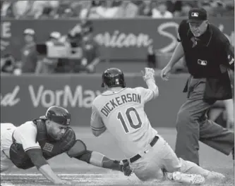  ?? NATHAN DENETTE, THE CANADIAN PRESS ?? Toronto Blue Jays catcher Russell Martin tags out Tampa Bay Rays designated hitter Corey Dickerson at home plate during third-inning action in Toronto on Wednesday. The Blue Jays hung on for a 7-6 win.