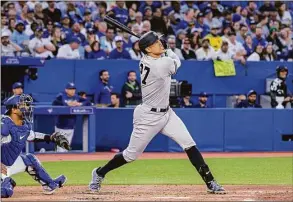  ?? Christophe­r Katsarov / Associated Press ?? The New York Yankees’ Giancarlo Stanton watches his home run against the Toronto Blue Jays during the fifth inning on Friday.