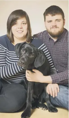  ??  ?? Six-month-old black Labrador Harris was given oxygen after being found unconsciou­s by Fiona Milne and Calum Campbell