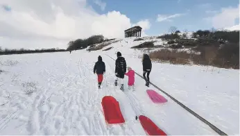 ??  ?? More snow fell on Penshaw Monument yesterday as thrill-seekers make their way to the top.