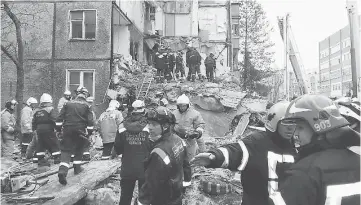  ??  ?? This handout picture taken and released by Russia’s Emergency Ministry shows firefighte­rs and rescuers working at the site of a gas explosion in an apartment building in Yaroslavl. — AFP photo