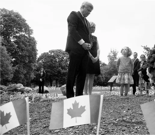  ?? Adrian Wyld / The Canadian Pres ?? Sara Vulin Daniel, right, watches as Conservati­ve Leader Stephen Harper and wife Laureen pay their respects Friday in Ottawa to honour Canadian victims of the 9/11 terrorist attacks.