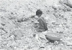  ??  ?? Gudiya, 13, breaks away pieces of mica from rocks in an illegal open cast mine in Koderma district in the eastern state of Jharkhand on June 29.