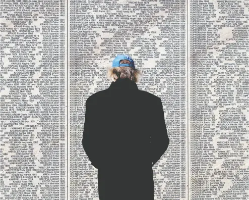  ?? JOE KLAMAR / AFP VIA GETTY IMAGES ?? A man stands in front of the Shoah Name Wall Memorial in Vienna after it opened to the public this week. The names of 64,440 Austrian Jews murdered during the Nazi era are inscribed as part of a new national reckoning.